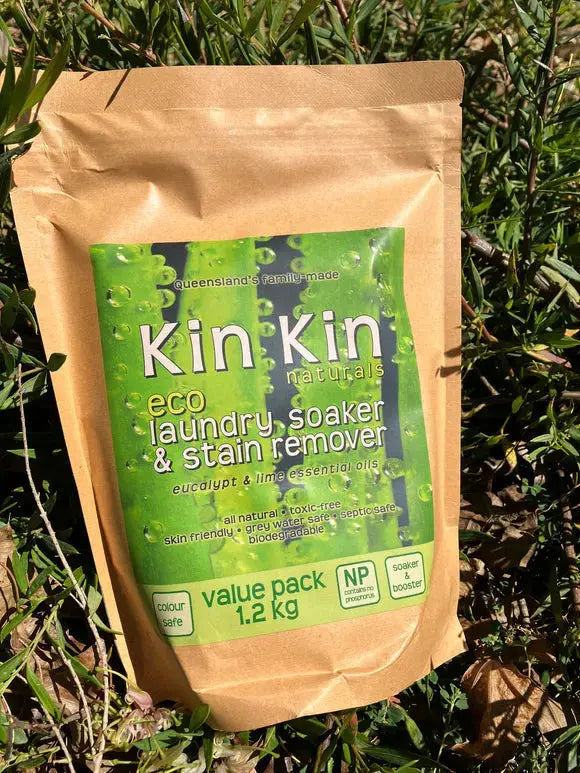 Kin Kin laundry soaker and stain remover beside a washing basket at home