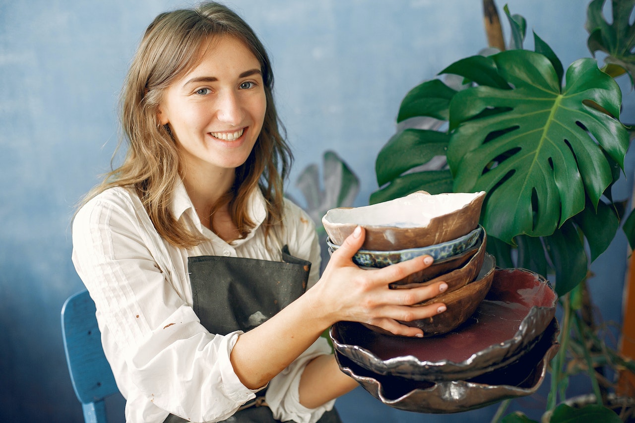 holding handmade ceramic dishware