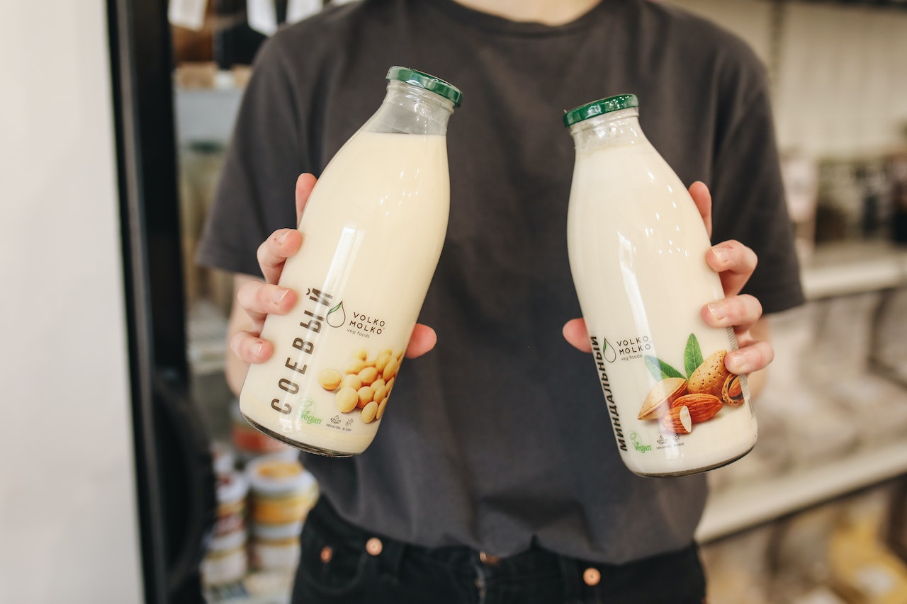 holding plant-based milk bottles