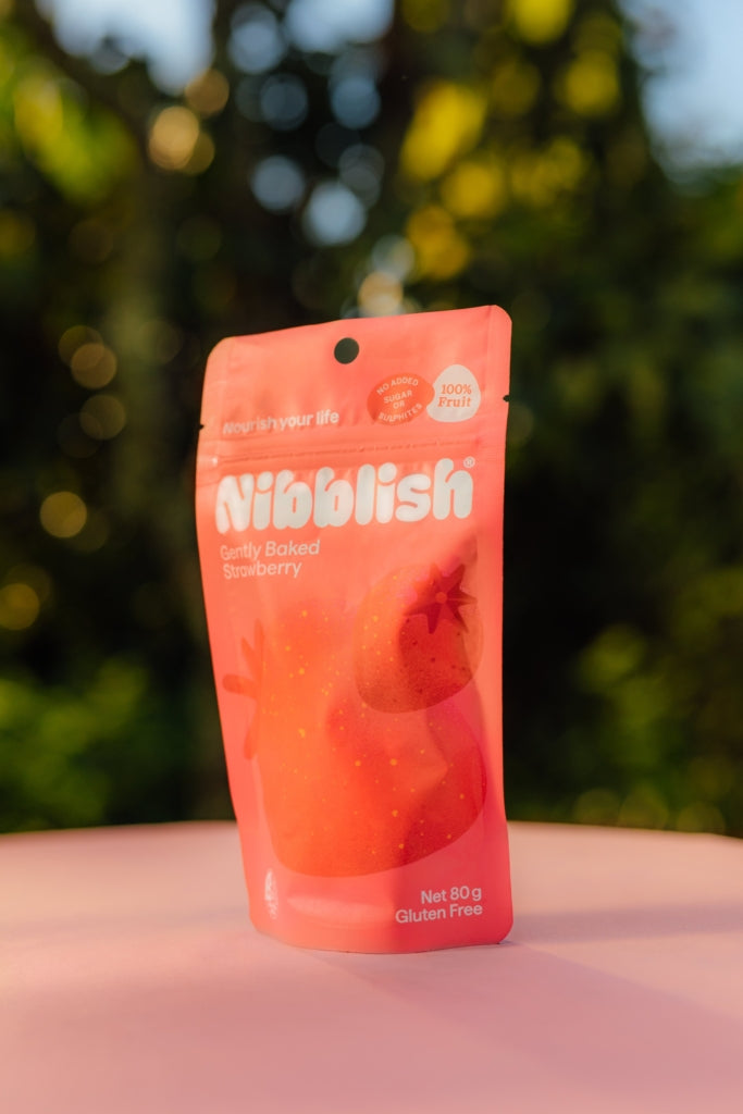 Nibblish Gently Baked Strawberry — outdoor snack lifestyle image
