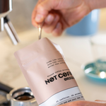 Not Coffee Original Ground — scooping into coffee machine lifestyle image