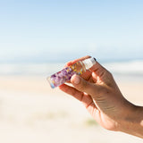 Summer Salt Sleep Essential Oil Roller — product held outdoors lifestyle image