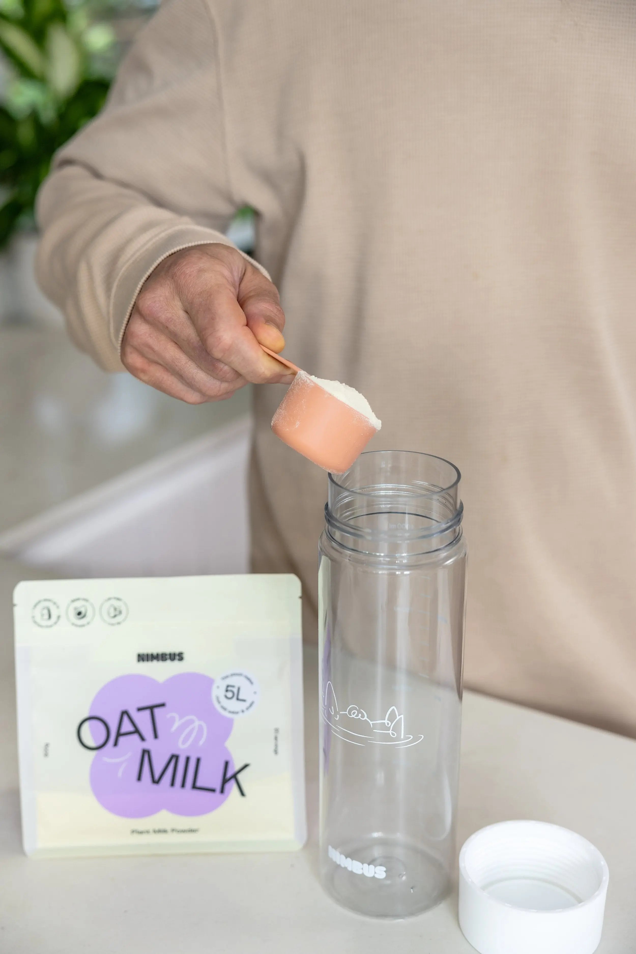 Scooping Nimbus Oat Milk powder