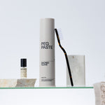Peg Paste Sacred Clove toothpaste with toothbrush in a minimalist bathroom
