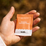 Sodii Salty Grapefruit electrolyte sachet held outdoors