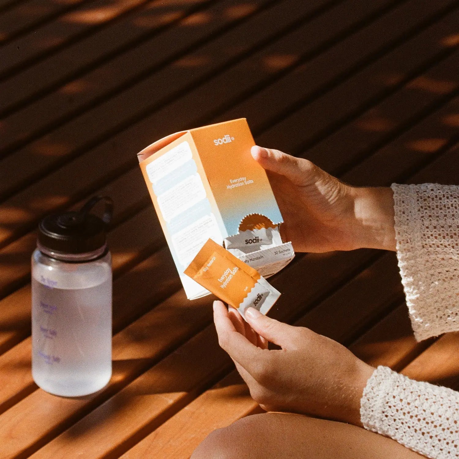 Sodii Salty Mandarin hydration salts box and sachet with water bottle