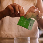 Sodii Salty Kiwi electrolyte sachet held outdoors