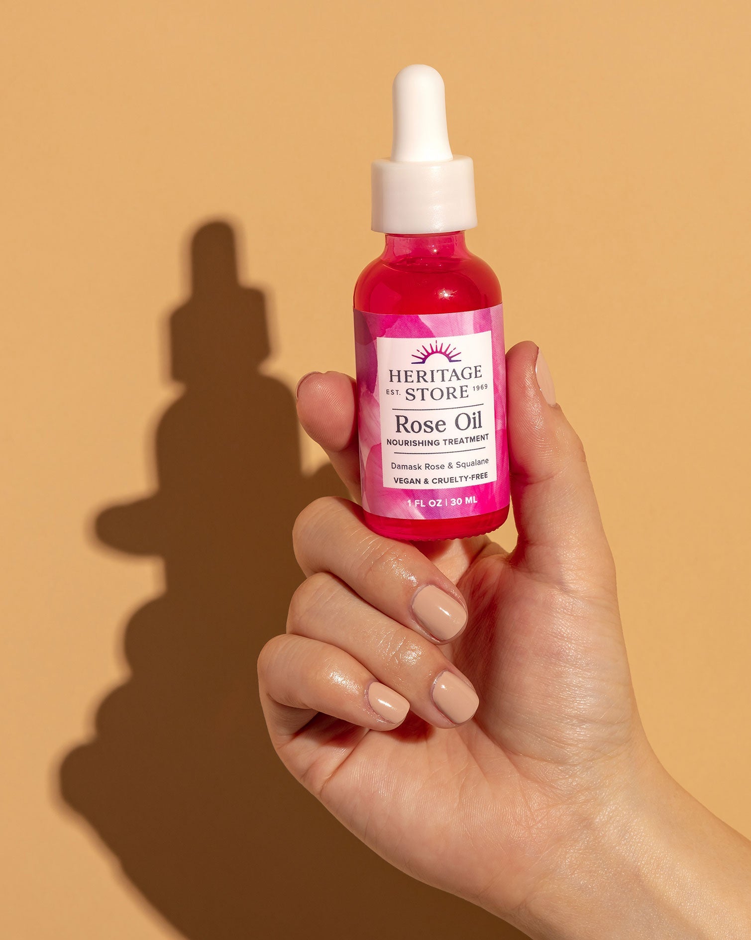 Heritage Store Rose Oil 30ml — official hand-held product lifestyle image